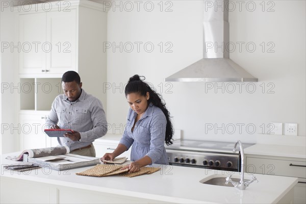 Couple examining fabric swatches in new home