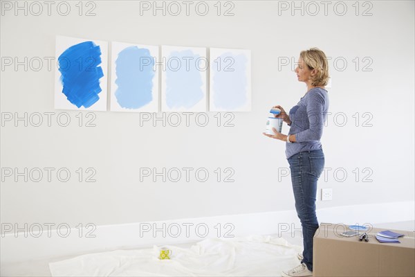 Caucasian woman examining paint samples in new home