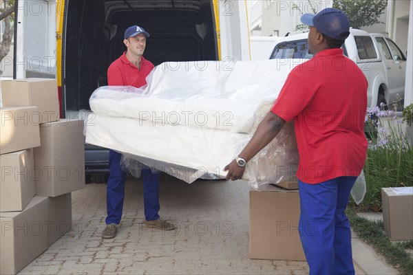 Movers carrying sofa to new home