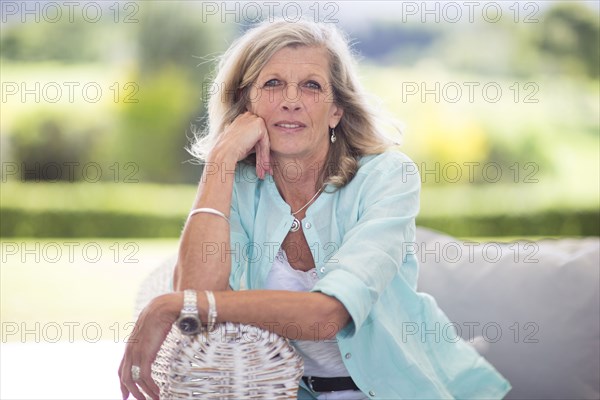 Caucasian woman sitting on sofa outdoors