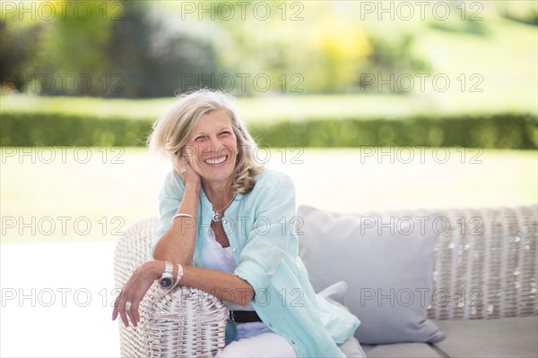 Caucasian woman sitting on sofa outdoors