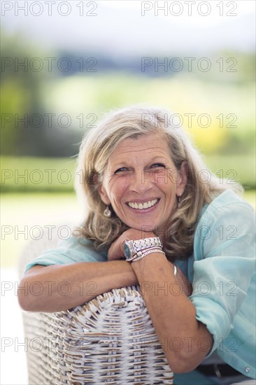 Caucasian woman sitting on sofa outdoors