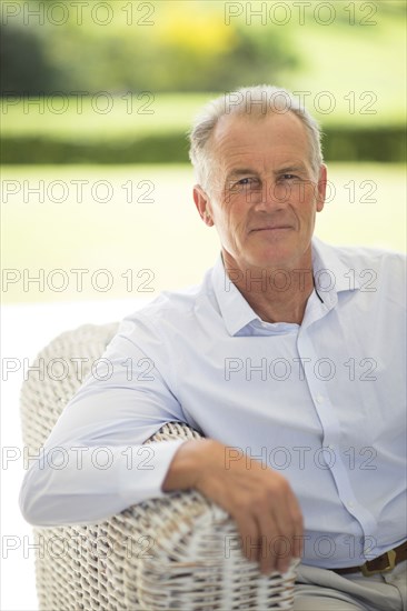Caucasian man sitting on sofa outdoors