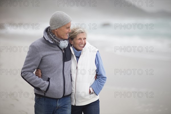 Caucasian couple hugging on beach