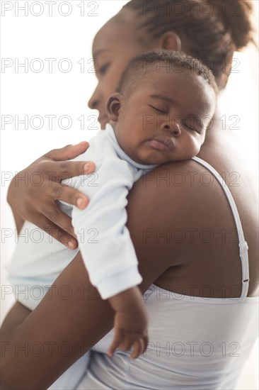 Close up of Black mother holding sleeping baby