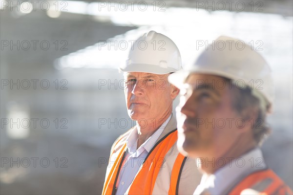 Caucasian architects standing at construction site