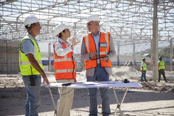 Architects talking at construction site