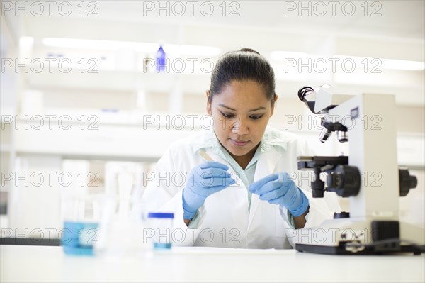Mixed race scientist working in laboratory
