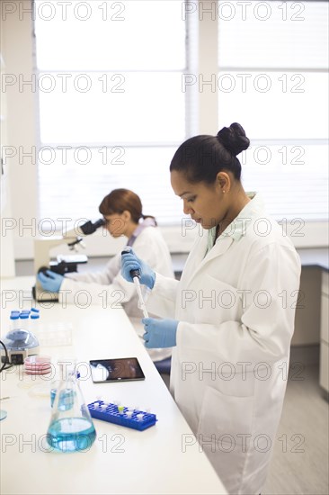Mixed race scientists working in laboratory