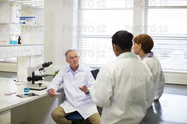 Scientists talking in laboratory