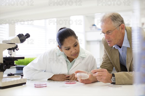 Businessman and scientist examining sample in laboratory