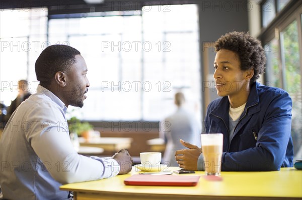 Men drinking coffee in cafe