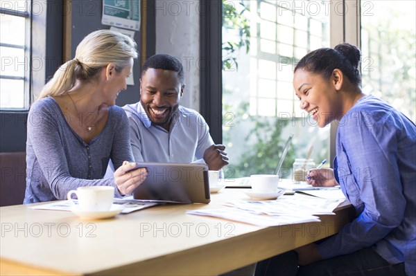 Business people using digital tablet in office meeting