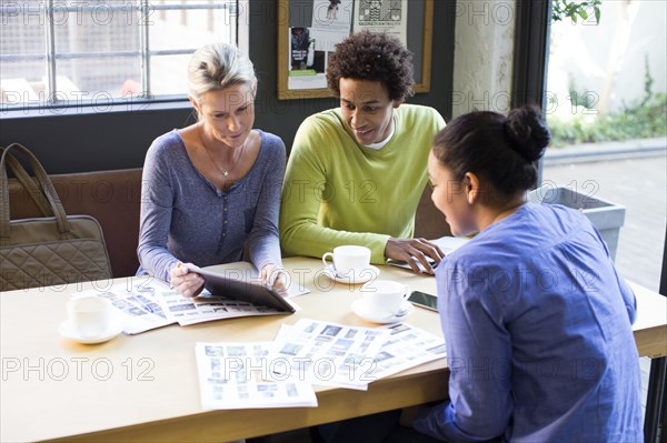 Business people using digital tablet in office meeting