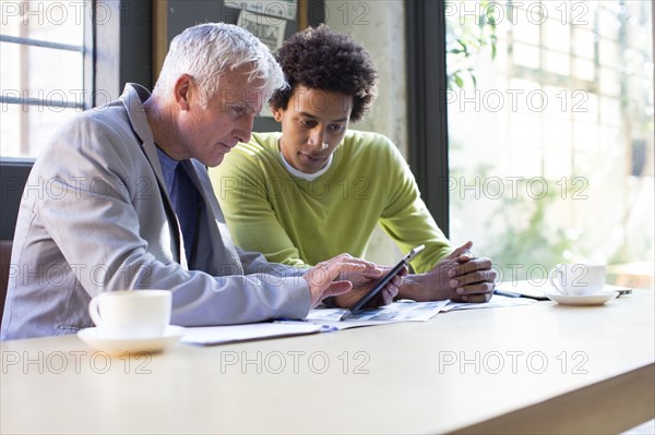 Business people using digital tablet in office meeting