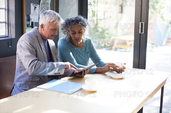 Business people using digital tablet in office meeting