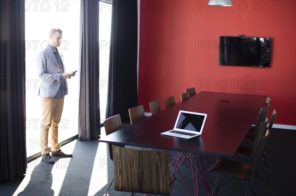 Caucasian businessman talking on cell phone in conference room