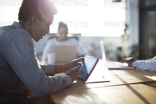 Mixed race business people using technology in office