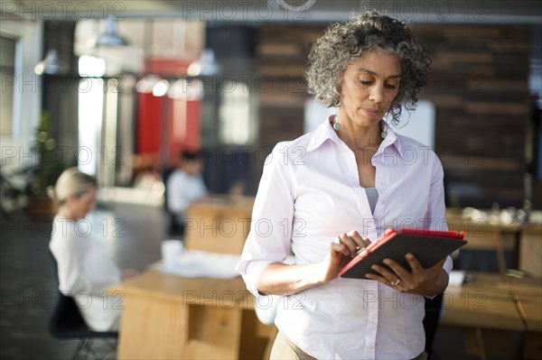 Businesswoman using digital tablet in office