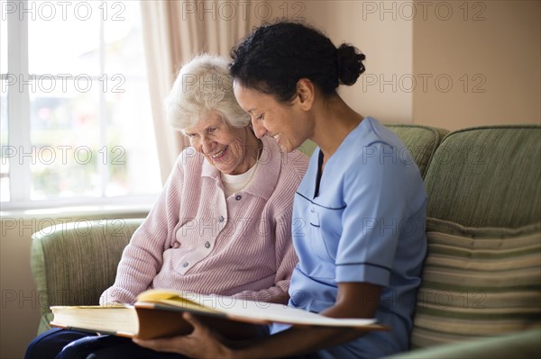 Nurse and patient looking at photo album