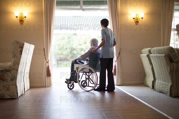 Nurse pushing patient in wheelchair