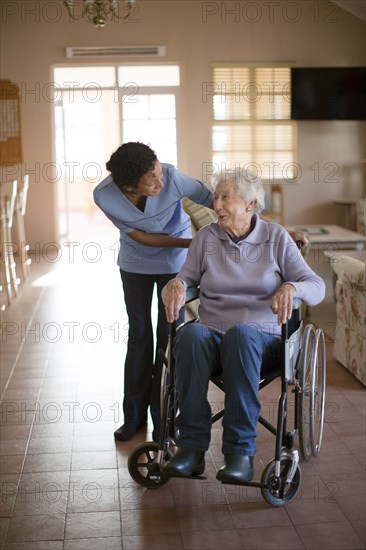 Nurse talking to patient in wheelchair