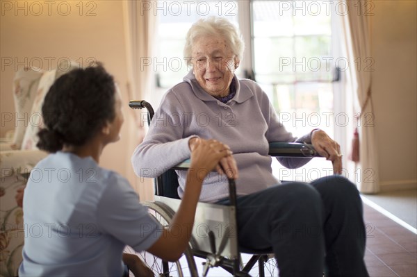 Nurse talking to patient in wheelchair