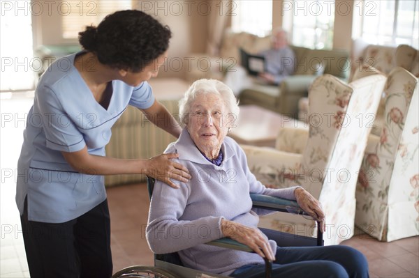 Nurse talking to patient in wheelchair