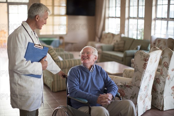 Doctor talking to patient in wheelchair