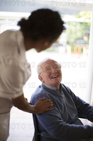 Doctor talking to patient in wheelchair