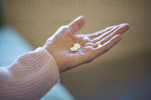 Older Caucasian woman holding medication