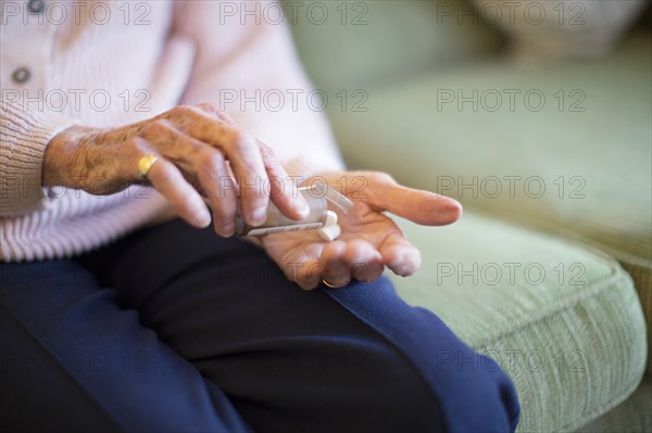 Older Caucasian woman holding medication