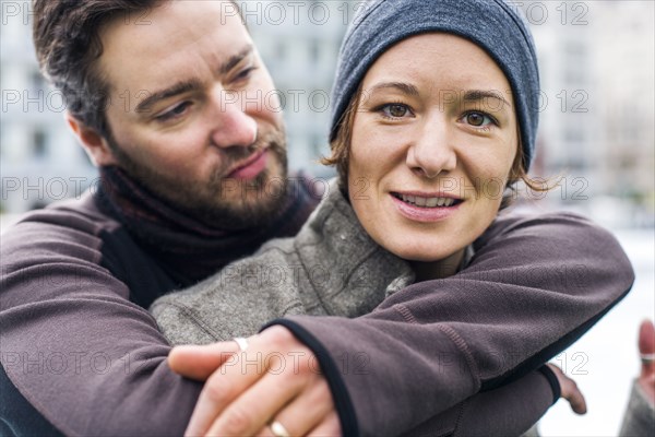 Portrait of Caucasian man hugging woman