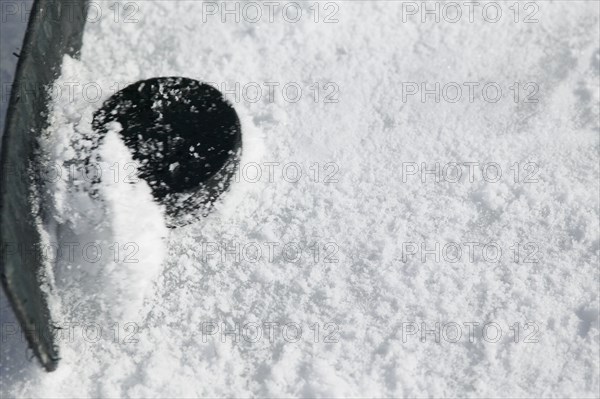 Close up of hockey stick and puck on ice