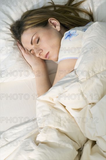 Young woman sleeping in bed