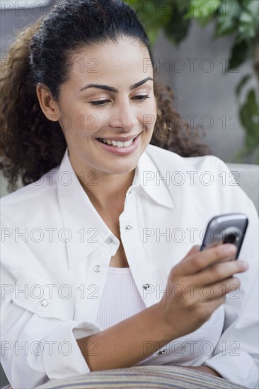Dominican woman looking at cell phone