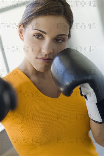 Mixed race woman boxing