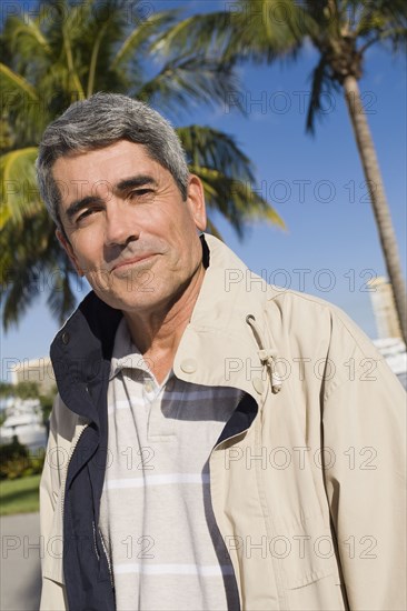 Cuban man standing in front of palm trees