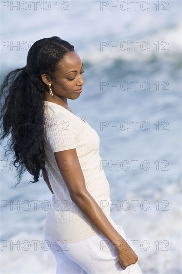 African woman walking near ocean