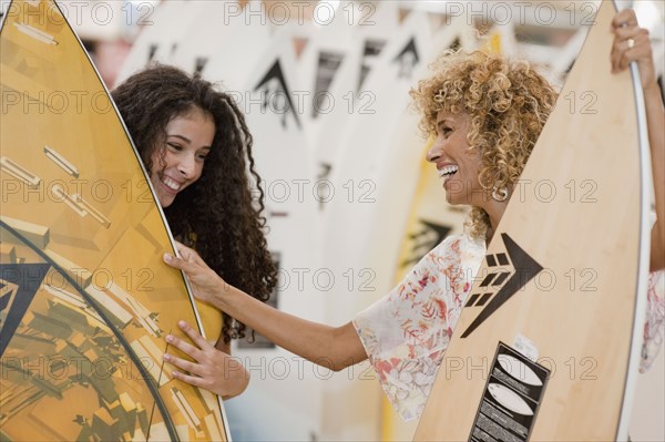 Israeli mother and daughter looking at surfboards