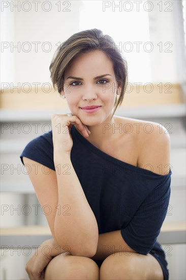 Glamorous Hispanic woman with hand on chin
