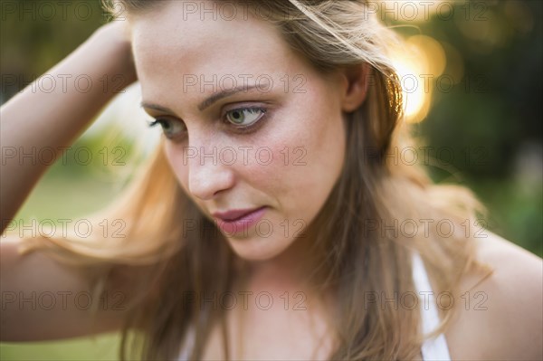 Serious Brazilian woman with head in hands