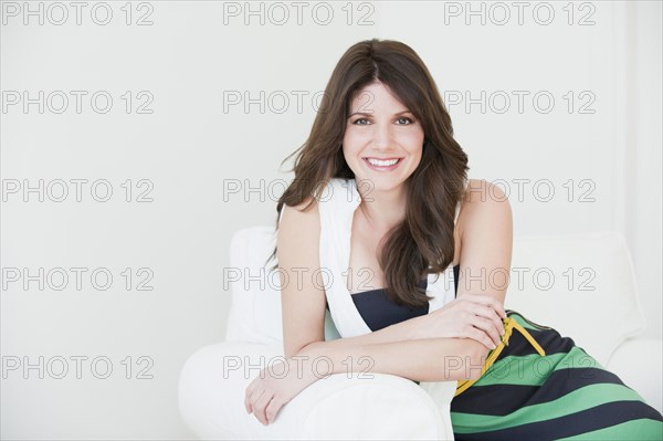 Smiling Cuban woman sitting in chair