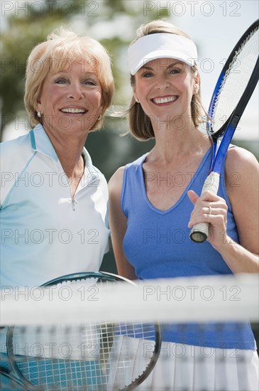 Caucasian women playing tennis