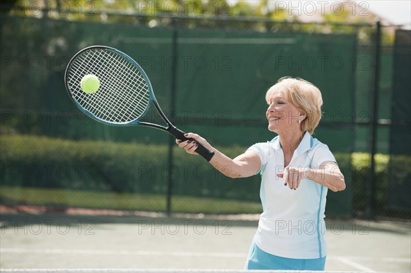 Caucasian woman playing tennis