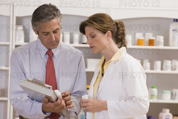 Caucasian co-workers working in pharmacy