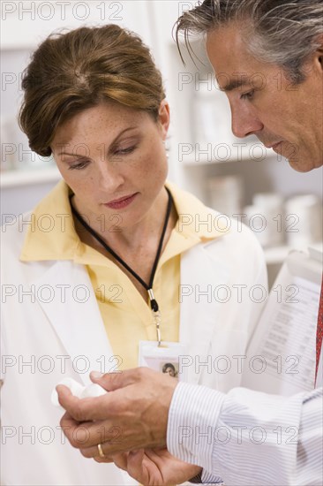 Caucasian co-workers working in pharmacy