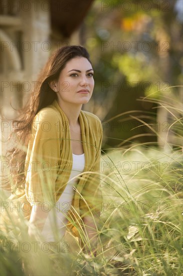 Serious Hispanic woman standing outdoors