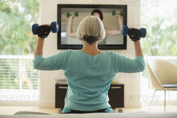 Caucasian woman exercising with hand weights