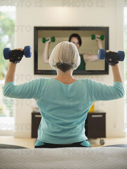 Caucasian woman exercising with hand weights